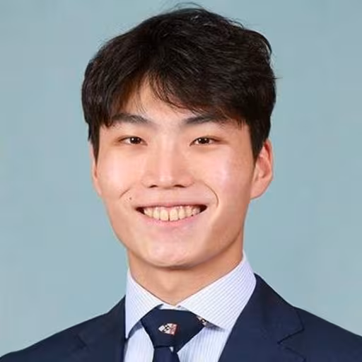 A Korean man flashes a grin.